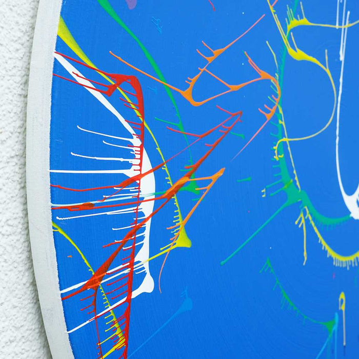 Das Gemälde "Splash 72" (Seitenperspektive) zeigt eine dynamische Komposition aus einer blauen Basis, ergänzt durch Akzente in Rot, Grün, Gelb und Weiß. Die abstrakten Pinselstriche verleihen dem Bild eine moderne und energetische Ausstrahlung, ideal für die Wohnraumgestaltung. Atelier Hellbusch.